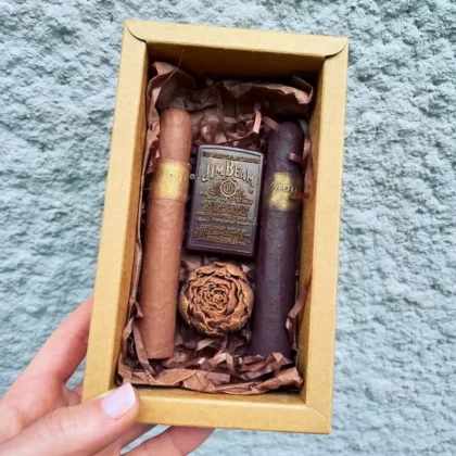 Coffret Homme de chocolats, comprenant un briquet, une fleure et deux cigares.